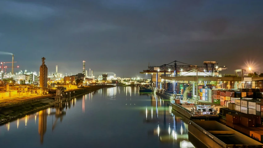 a large body of water next to a city at night, by Matthias Stom, pexels contest winner, shipping containers, helmond, maintenance photo, thumbnail