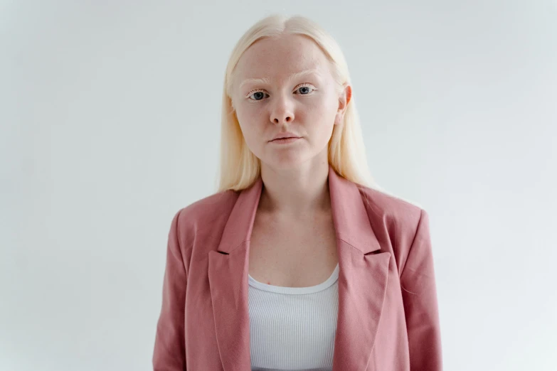 a woman with blonde hair wearing a pink blazer, inspired by Vanessa Beecroft, trending on pexels, hyperrealism, albino dwarf, greta thunberg as gollum, realistic face and body hybrid, a very macular woman in white