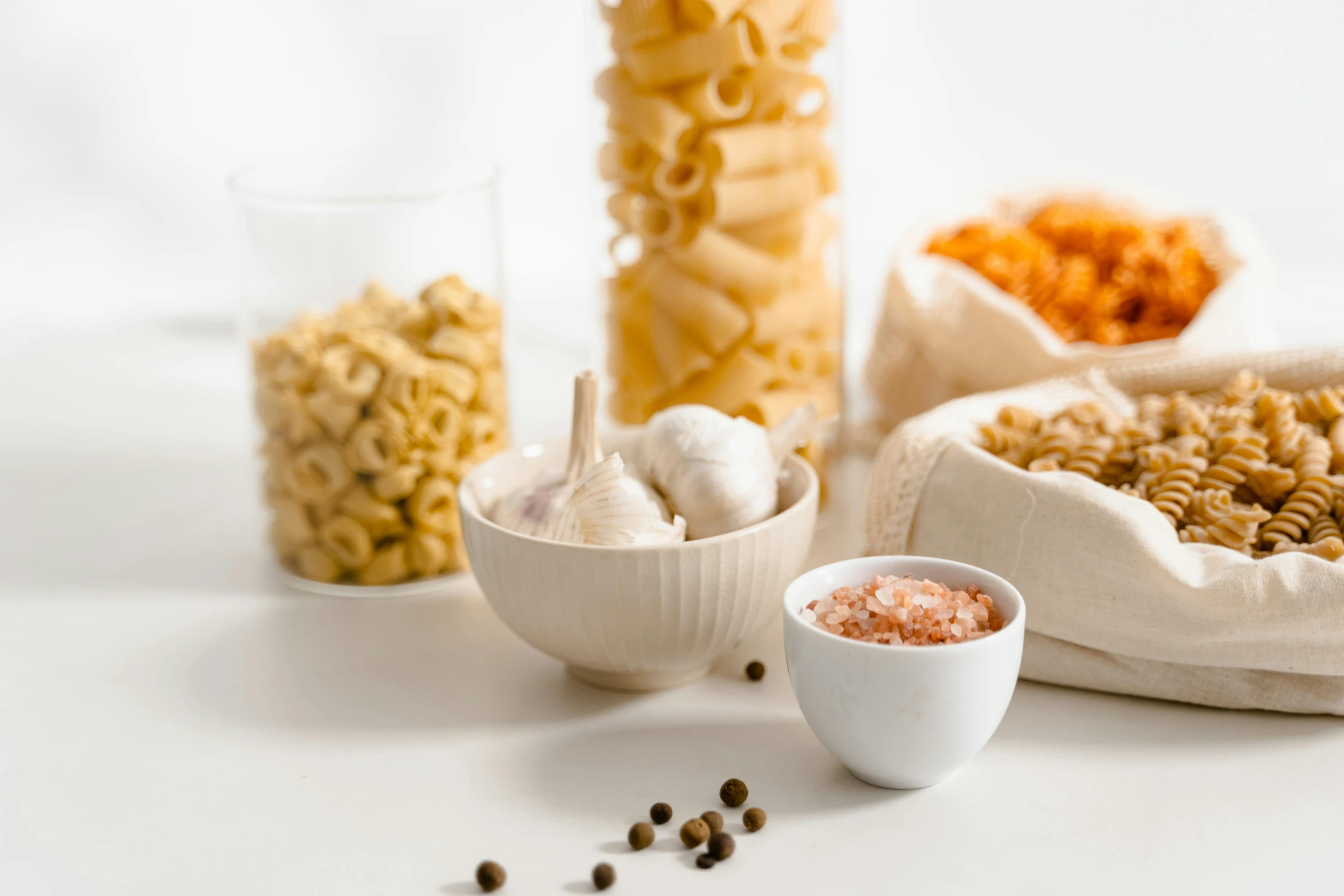 a table topped with bowls of different types of pasta, pexels, renaissance, background image, white, white and orange, products shot