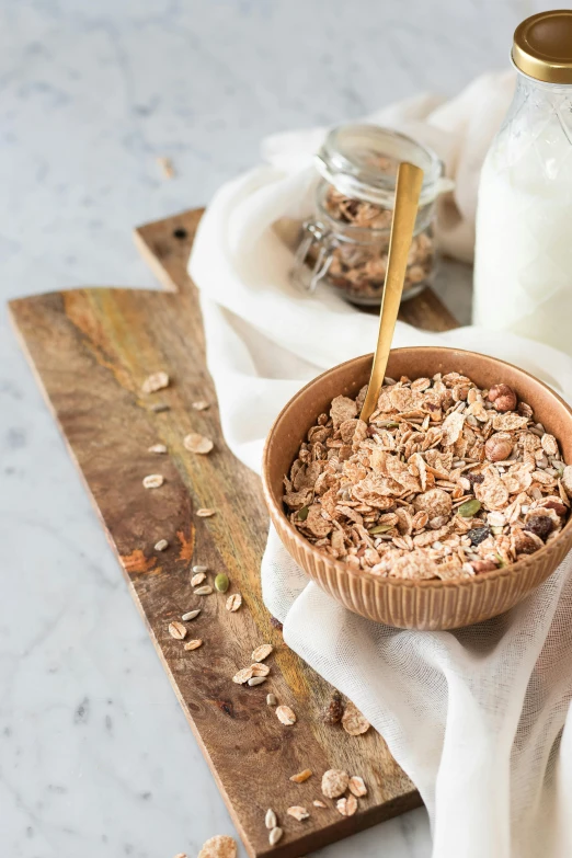 a bowl of oatmeal next to a bottle of milk, trending on pexels, renaissance, natural wood top, seeds, panoramic, high quality product image”