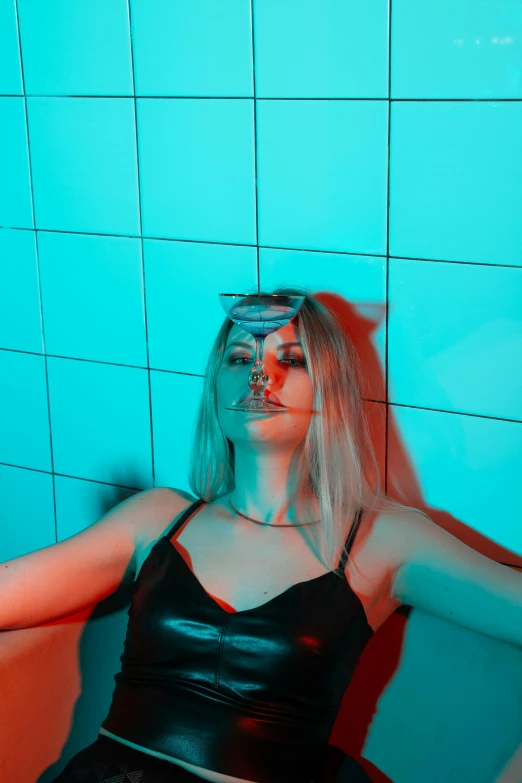 a woman in a black dress sitting in a bathtub, inspired by Elsa Bleda, trending on pexels, holography, red and cyan, wearing an eye patch, blonde women, in a nightclub