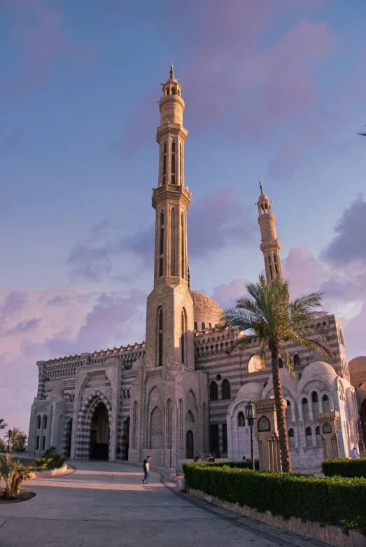 a large white building with a clock tower, by Ahmed Yacoubi, arabesque, during golden hour, minarets, oceanside, square