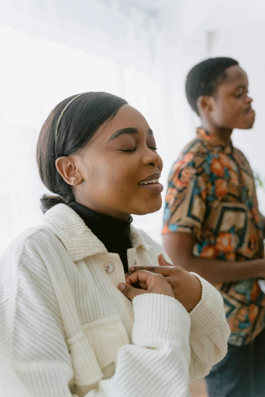 a couple of people standing next to each other, trending on pexels, renaissance, praying, african american young woman, a still of a happy, centered in image