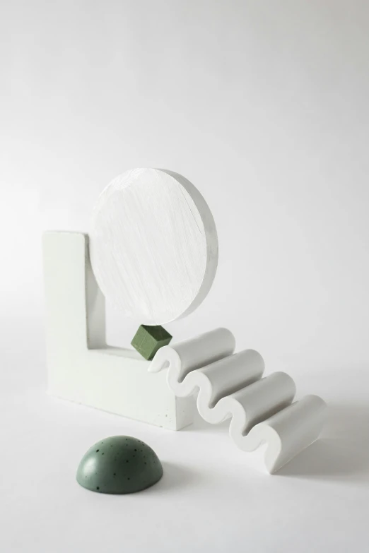 a white object with a green object next to it, an abstract sculpture, inspired by Isamu Noguchi, rolling mountain, ilustration, anna nikonova, section model