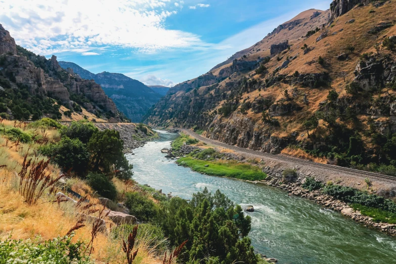 a train traveling down a train track next to a river, by Josh Bayer, unsplash contest winner, hurufiyya, canyon background, washington, river of wine, panels