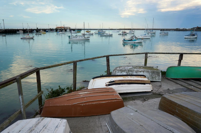 a number of boats on a body of water, a picture, pexels contest winner, australian tonalism, benches, patina, where a large, coastal