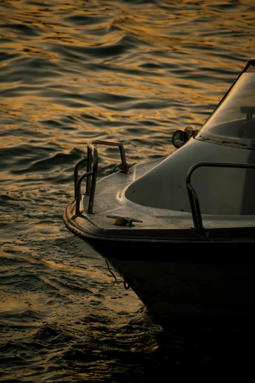 a boat sitting on top of a body of water, by Dan Christensen, pexels contest winner, tonalism, golden hour closeup photo, yellow, navy, grey