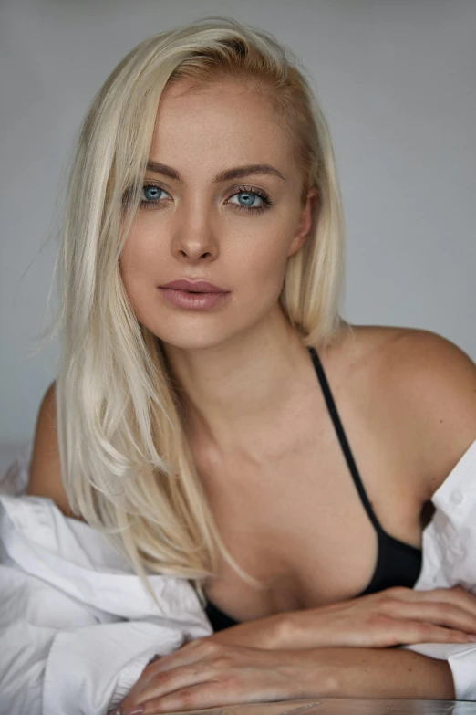 a beautiful blond woman laying on top of a bed, inspired by Károly Lotz, reddit, photorealism, robe. perfect faces, headshot photoshoot, blue eyed, stunning closeupheadshot