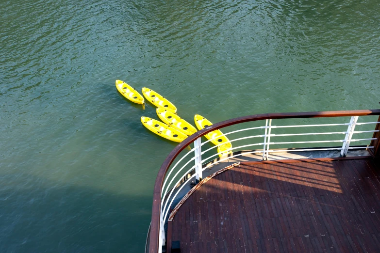 a yellow raft floating on top of a body of water, on ship, gondolas, flat lay, amanda lilleston