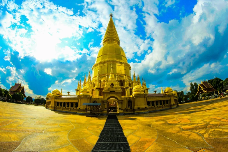 a yellow pagoda with a blue sky in the background, unsplash contest winner, fisheye lens photography, square, patiphan sottiwilai, gold plated