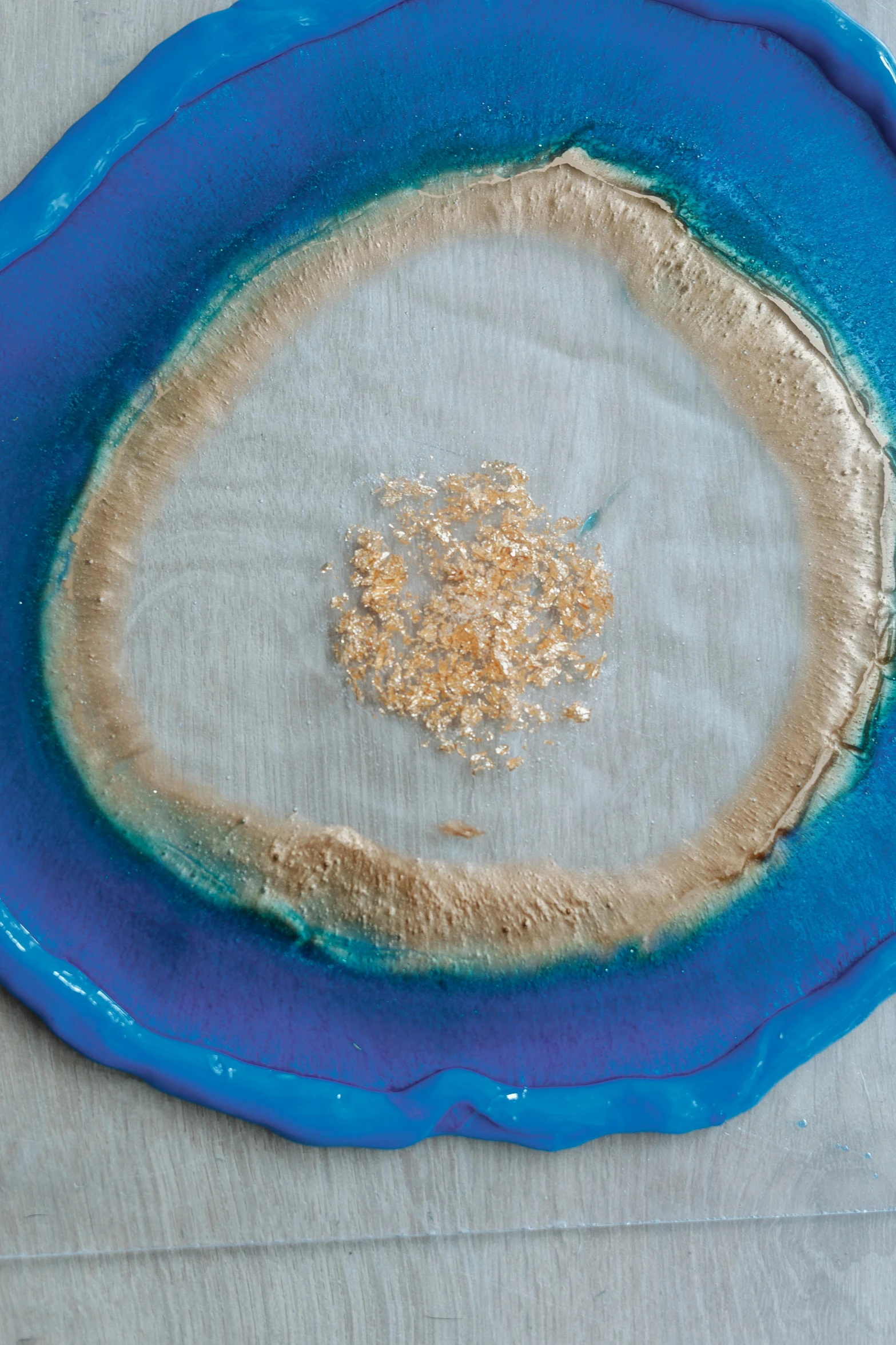 a close up of a plate on a table, by Ellen Gallagher, gutai group, gold and blue, an island made of caviar, made of lab tissue, yeast