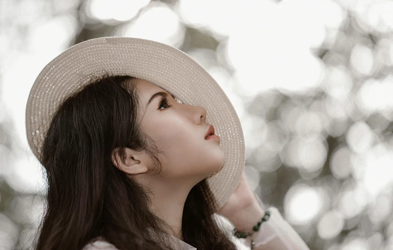 a close up of a person wearing a hat, inspired by Cheng Jiasui, pexels contest winner, aestheticism, young woman looking up, side pose, peaceful expression, white straw flat brimmed hat