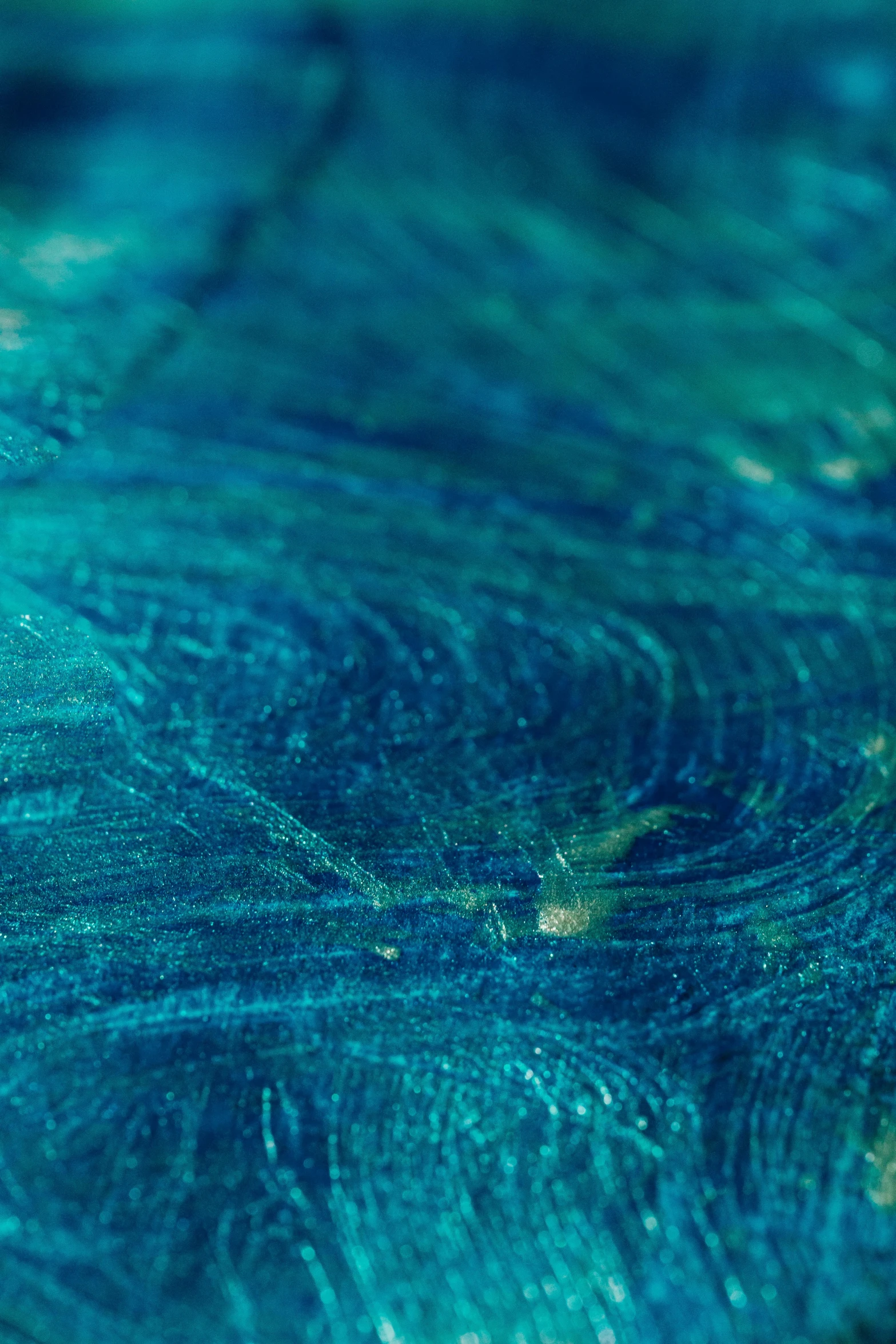 a close up of a surfboard on a body of water, inspired by Mikalojus Konstantinas Čiurlionis, trending on unsplash, lyrical abstraction, raw malachite, blue: 0.25, made of silk paper, detail shot