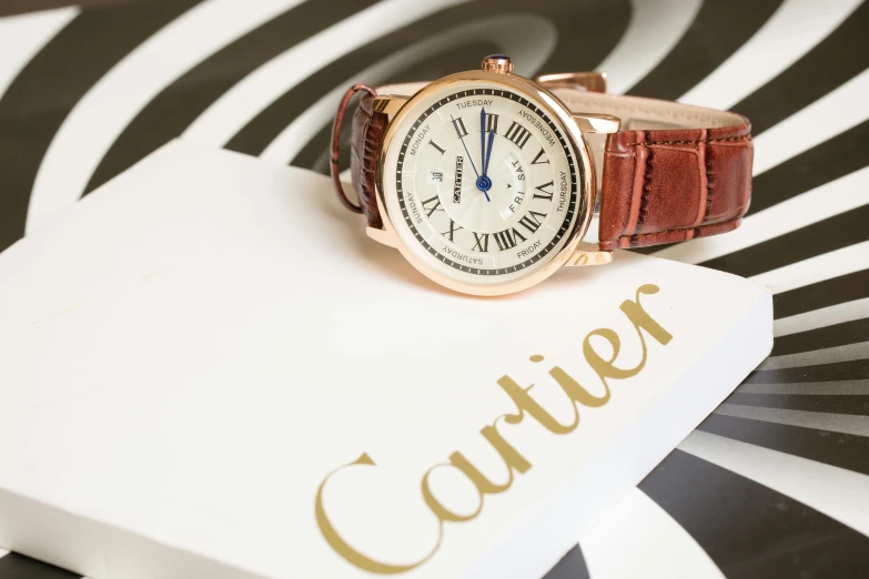 a cartier watch sitting on top of a box, a portrait, inspired by Cafer Bater, instagram, circular, profile image, ivory and copper, magazine photo