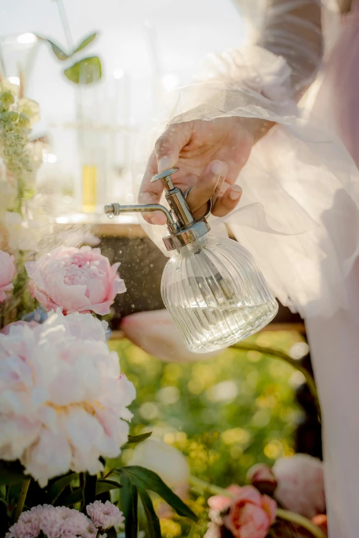 a close up of a person pouring water on flowers, inspired by Christian Krohg, luxurious wedding, in bloom greenhouse, pink, full - view