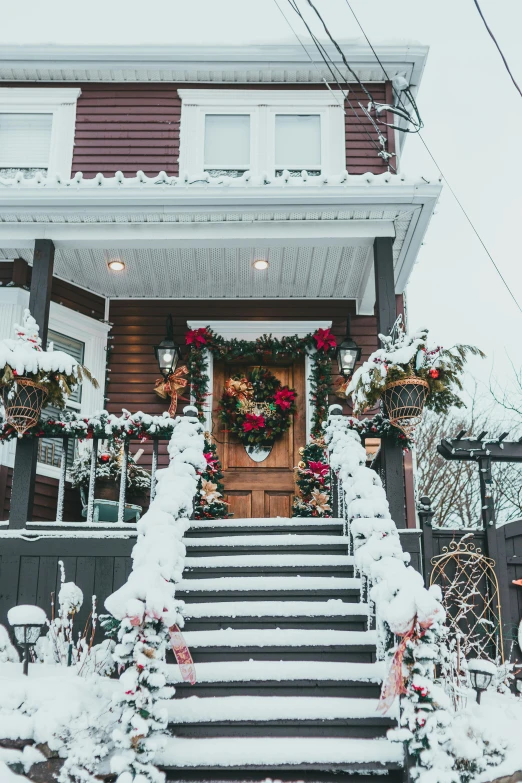 the front steps of a house covered in snow, pexels contest winner, folk art, flowers around, holiday, maroon, multiple stories