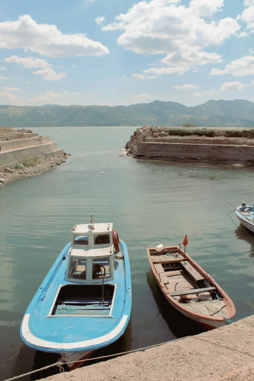 a couple of boats that are sitting in the water, by Muggur, dau-al-set, wall of water either side, panorama shot, taken in the late 2000s, small dock