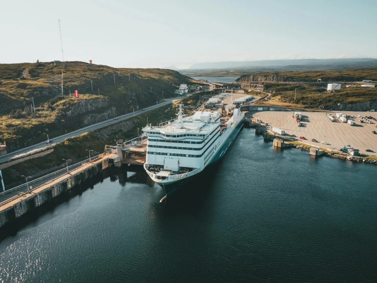 a large cruise ship in a body of water, by Matthias Stom, pexels contest winner, happening, docked at harbor, drone photograpghy, quebec, stålenhag