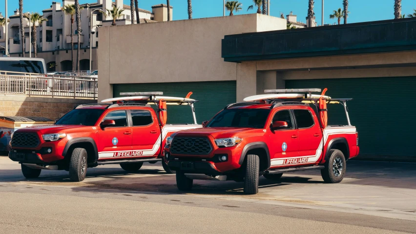 a couple of red trucks parked next to each other, unsplash, renaissance, oceanside, firefighting gear, avatar image, with a roof rack