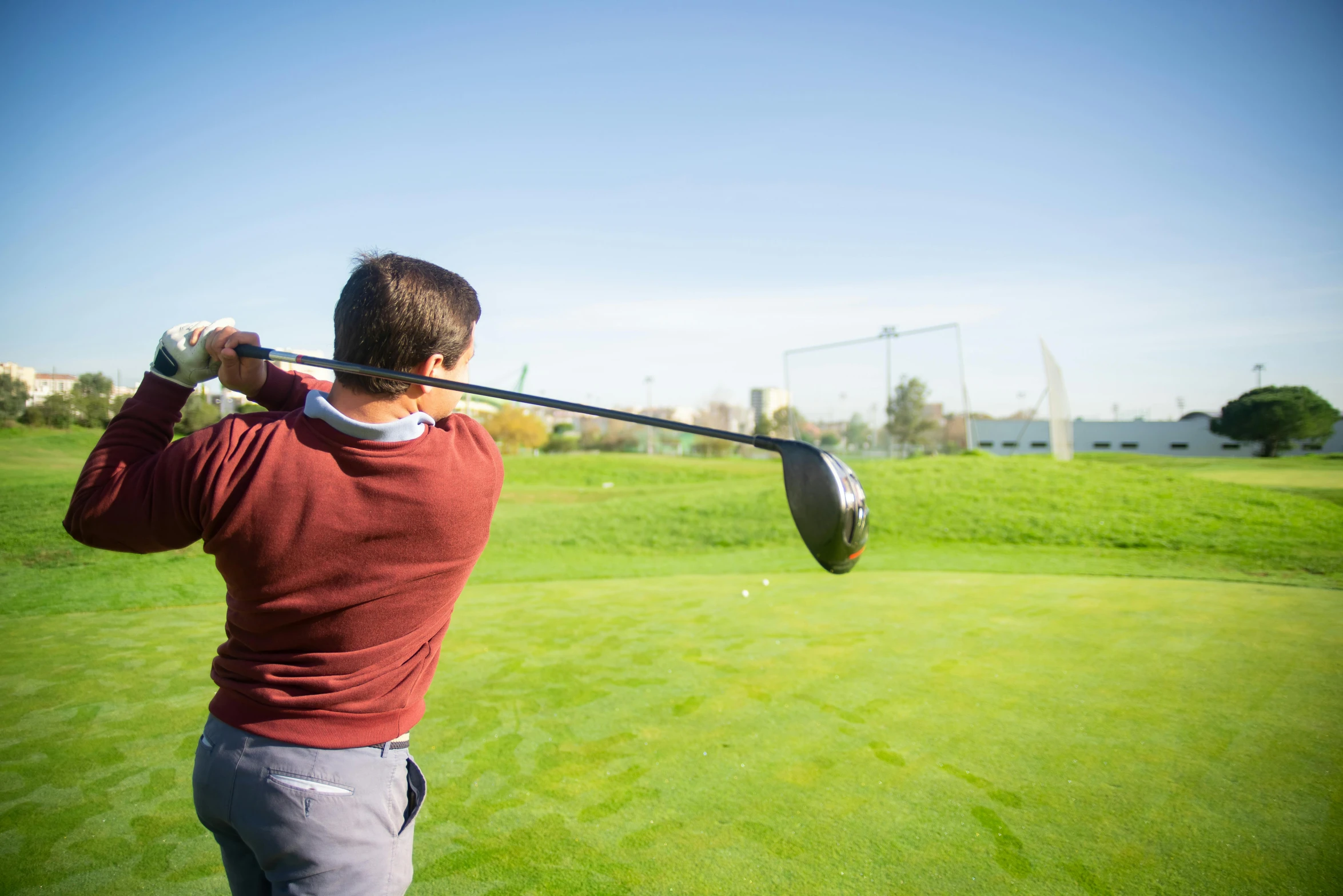 a man swinging a golf club at a golf course, pexels contest winner, happening, avatar image, half turned around, sportspalast amphitheatre, medium close shot