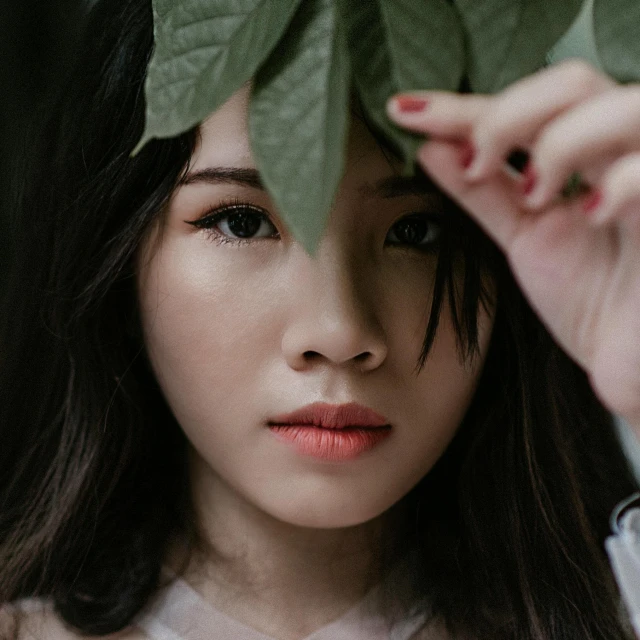 a woman holding a leaf over her head, trending on pexels, realism, asian face, pouty lips, girl with white eyes, stylized