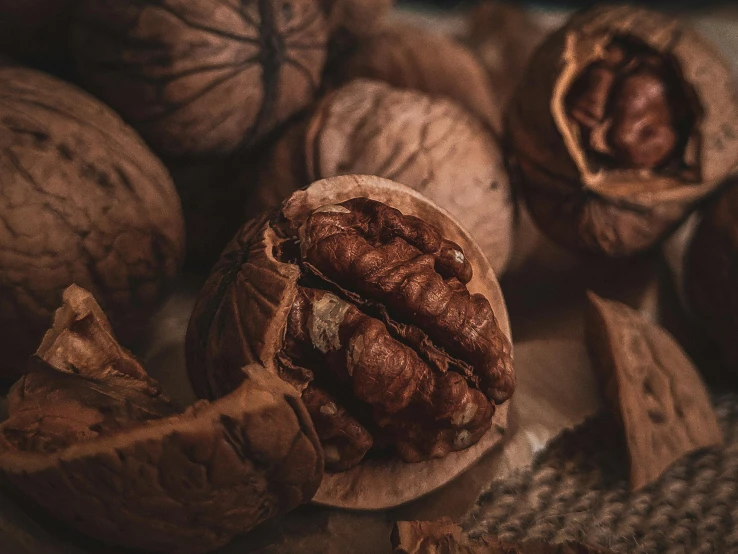 a pile of walnuts sitting on top of a table, pexels contest winner, 🦩🪐🐞👩🏻🦳, cinnamon skin color, crisp details, brown haired