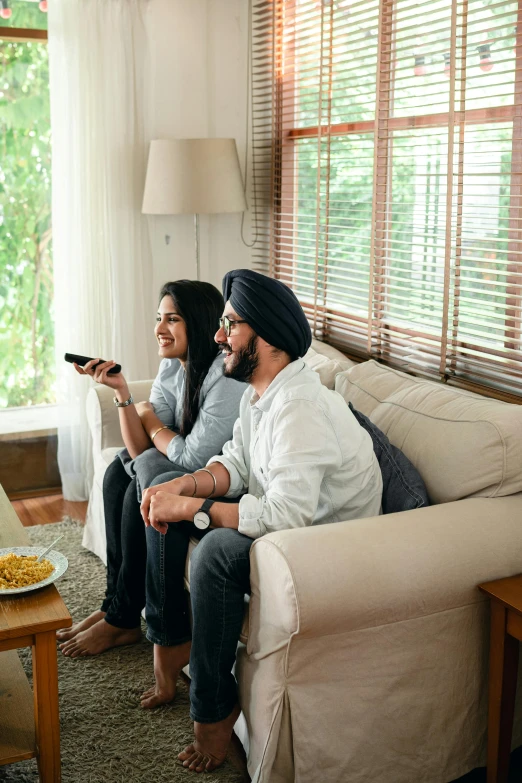 a group of people sitting on a couch watching tv, indian, smiling couple, square, connectivity