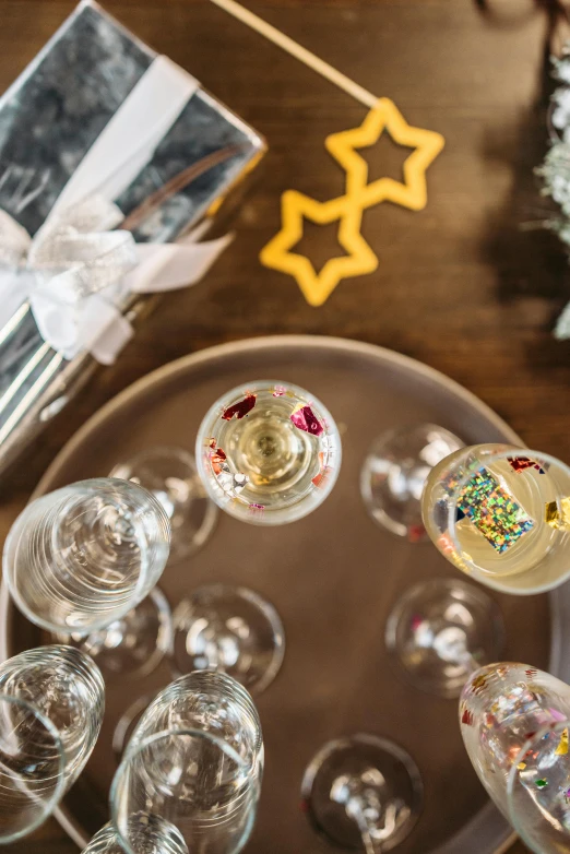 a bunch of wine glasses sitting on top of a table, tiny stars, toys, flatlay, up close