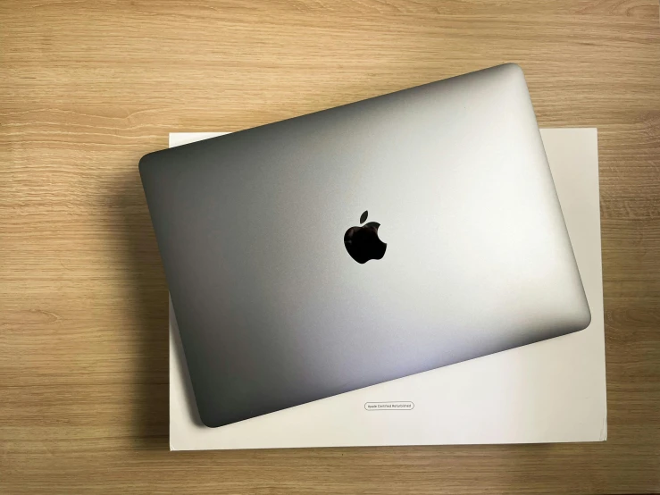 an apple laptop sitting on top of a box, a stipple, unsplash, photorealism, gradient black to silver, 🦩🪐🐞👩🏻🦳, very large, still in package