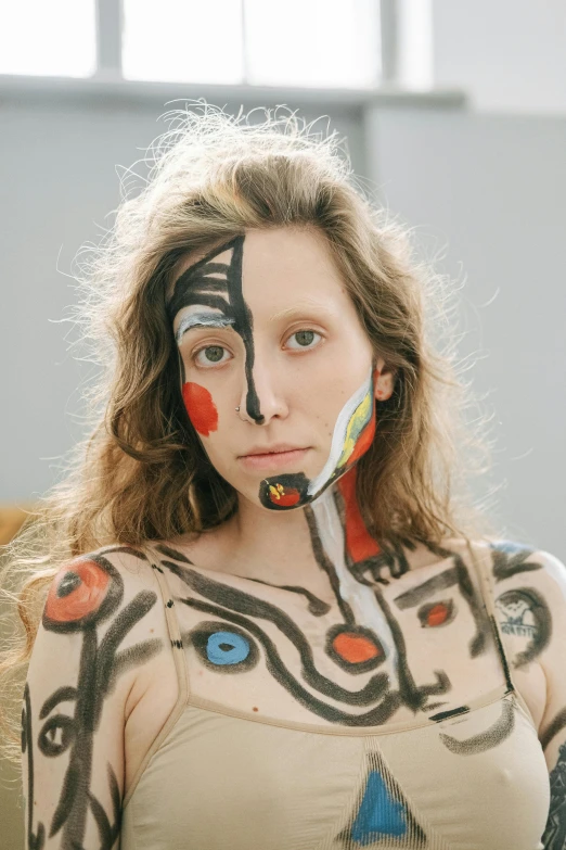 a woman with painted face and body poses for a picture, an album cover, inspired by Julia Pishtar, renaissance, google arts and cultures, candid portrait photo, miro, shot with sony alpha