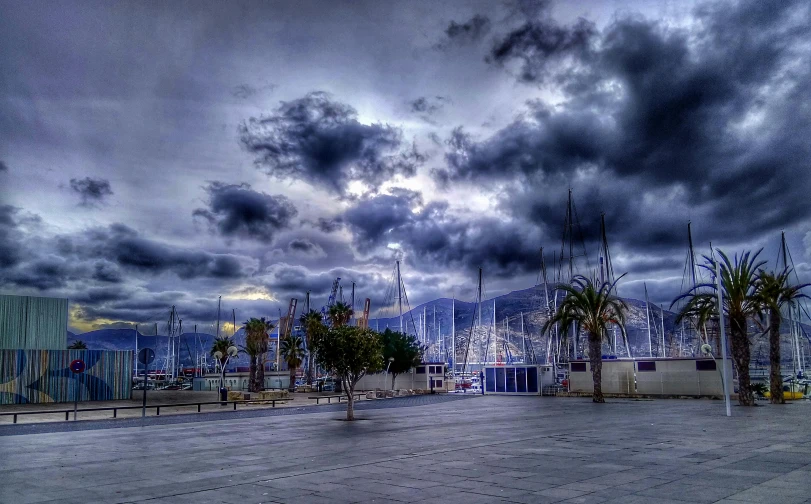 a cloudy sky over a marina with palm trees, by Michalis Oikonomou, pexels contest winner, romanticism, stormy night, sailboats, thunder clouds modernism, post+processing