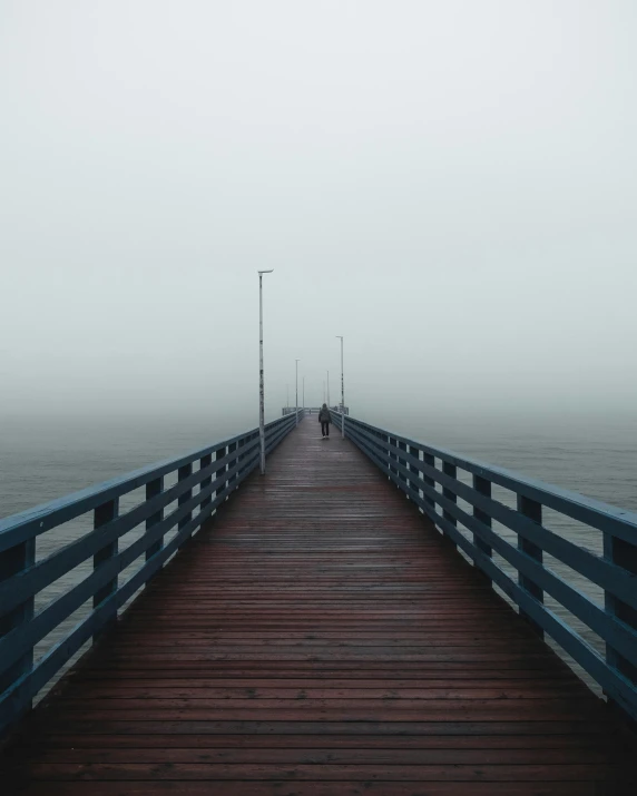 a pier on a foggy day with people walking on it, pexels contest winner, romanticism, non-binary, looking sad, about to step on you, photo of cthulhu