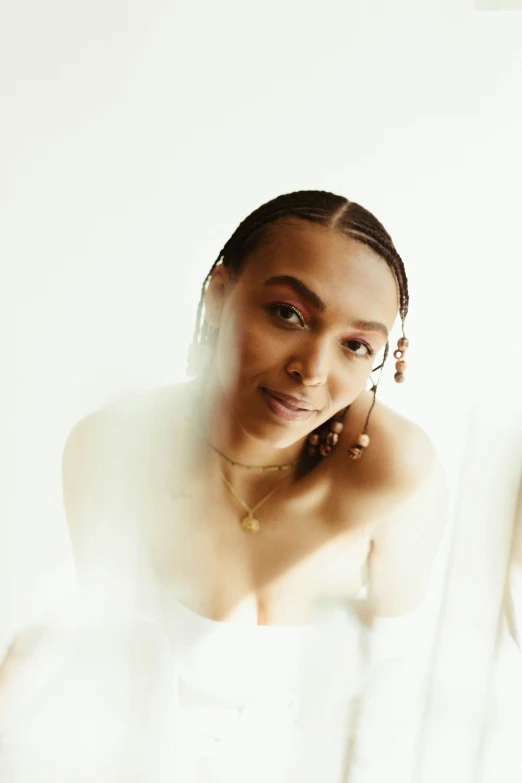 a woman in a wedding dress standing in front of a mirror, an album cover, by Cosmo Alexander, trending on pexels, renaissance, doja cat, headshot portrait, bathing in light, in front of white back drop