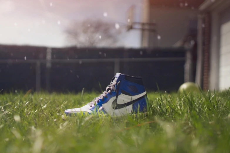 a pair of sneakers sitting on top of a lush green field, a portrait, by Gavin Nolan, unsplash, hyperrealism, hyper realistic octane render 4k, cinematic opening shot, air jordan 1 high, baseball