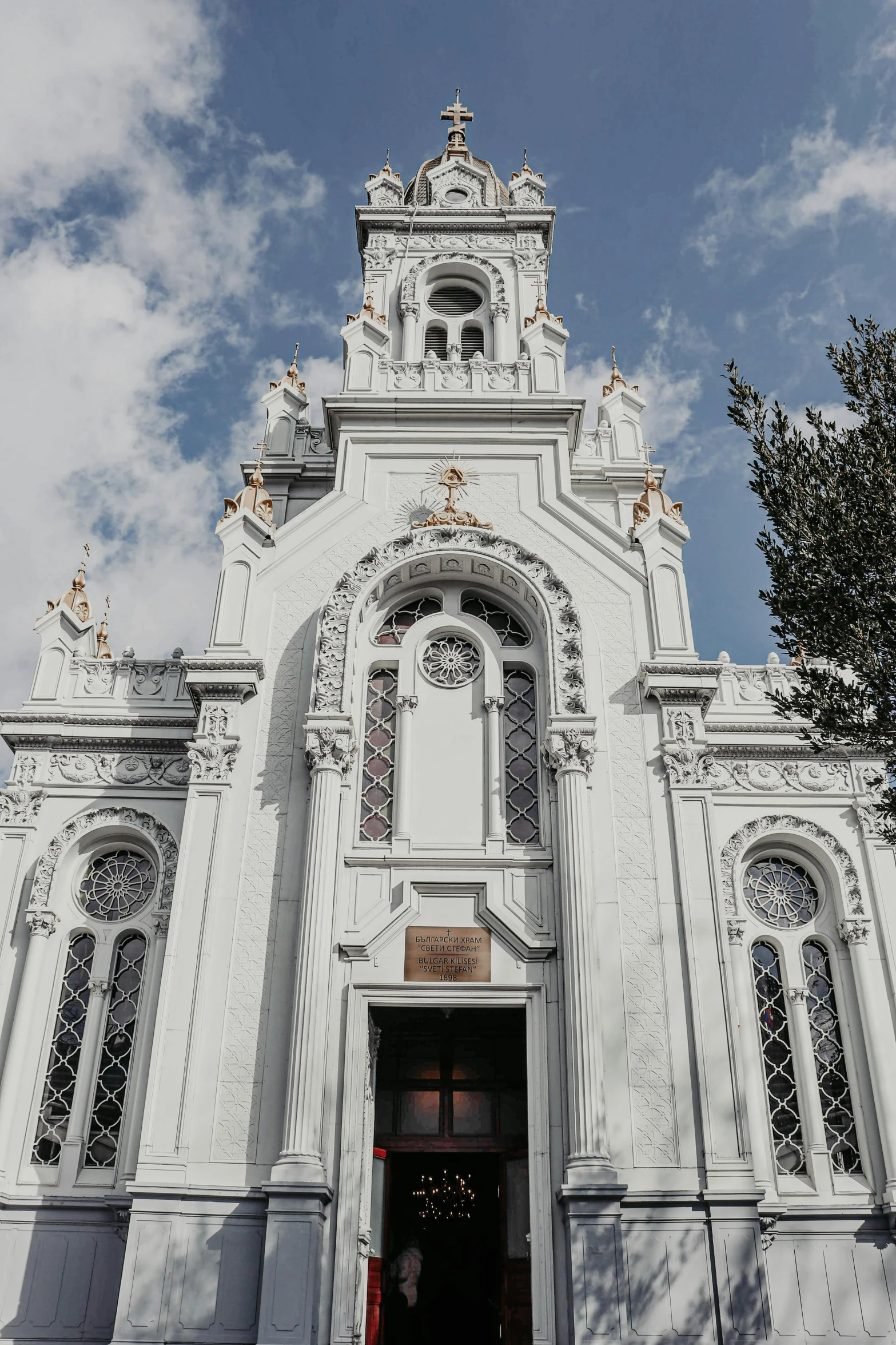 a large white church with a clock tower, an album cover, unsplash contest winner, baroque, chile, grey, entrance, gold