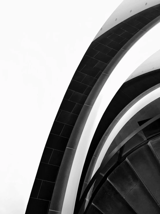 a black and white photo of a spiral staircase, an abstract sculpture, by Bauhaus, unsplash, minimalism, shot with iphone 1 0, arches, black & white photograph, crisp lines and color