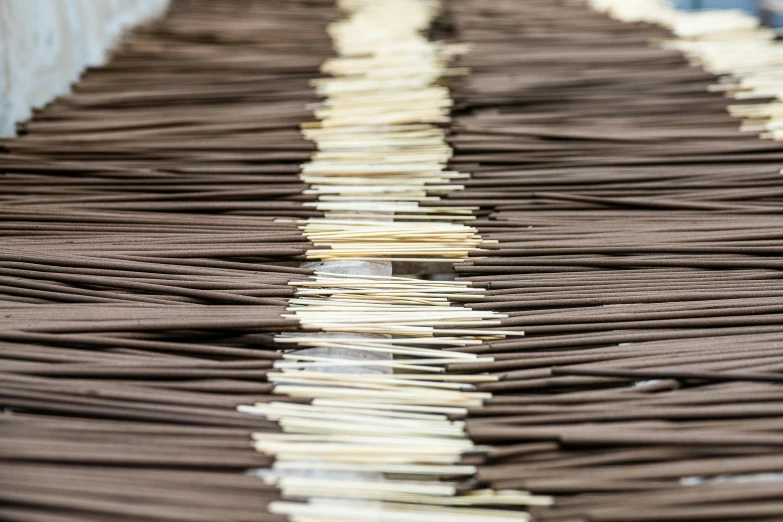 chocolate sticks are lined up on a conveyor belt, a portrait, by Daniel Lieske, unsplash, process art, thatched roofs, acupuncture treatment, linen, ultra - detail