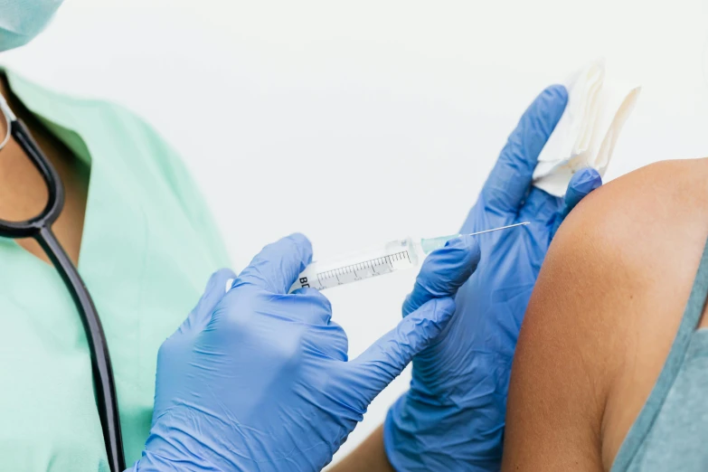 a nurse is giving an injection to a patient, a photo, by Adam Marczyński, shutterstock, aerial iridecent veins, blue, profile pic, brown