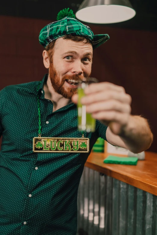 a man standing in front of a bar holding a drink, pexels contest winner, wearing elaborate green and gold, clover, 🐿🍸🍋, adafruit