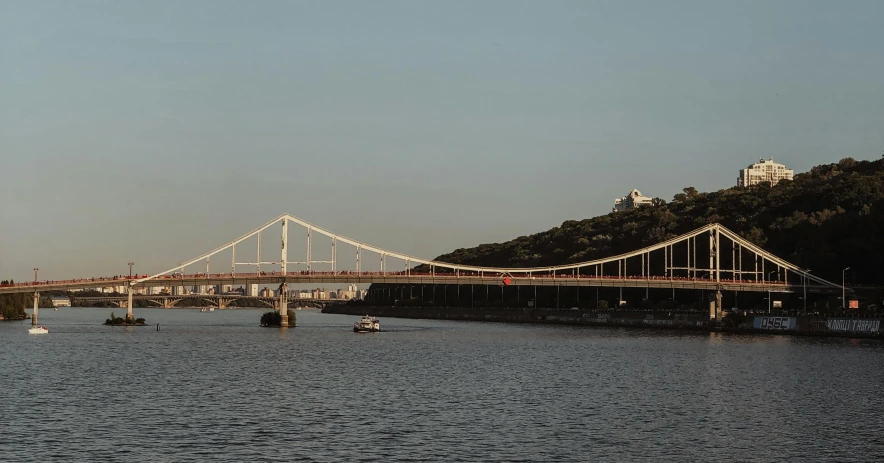 a bridge over a large body of water, by Xavier Blum Pinto, pexels contest winner, modernism, neo kyiv, hills in the background, jerez, alvar aalto