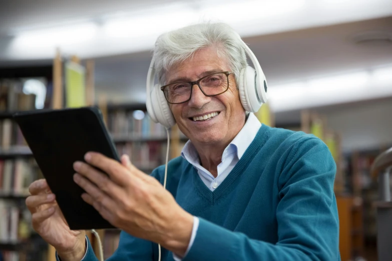 a man wearing headphones and listening to music on a tablet, silver haired, multiple stories, a still of a happy, schools