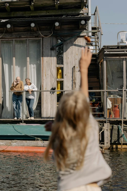 a group of people standing on top of a boat, by Jan Tengnagel, pexels contest winner, photorealism, standing outside a house, waving hands, parents watching, shot from cinematic