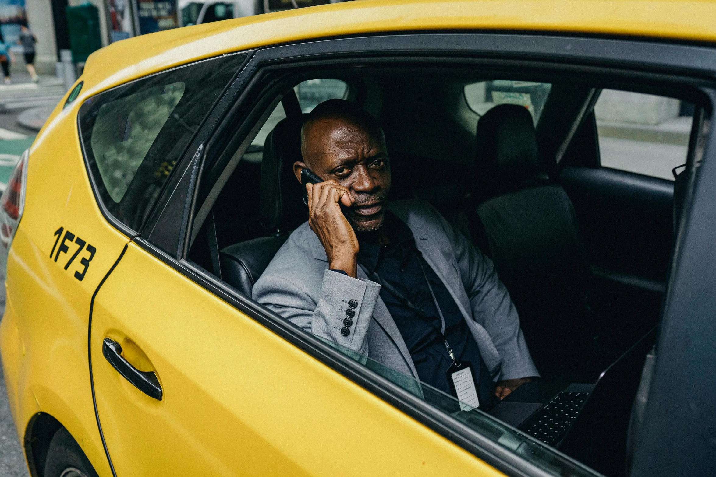 a man sitting in a taxi talking on a cell phone, pexels contest winner, happening, lance reddick, black and yellow, ready for a meeting, instagram post