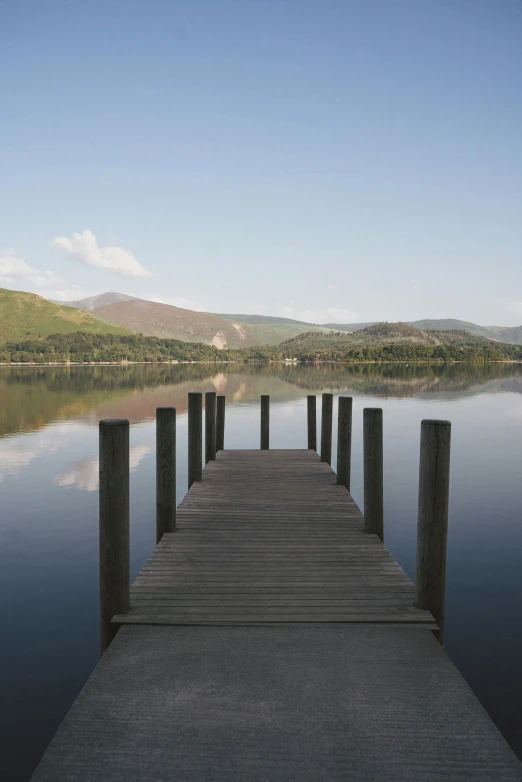 a dock on a lake with mountains in the background, by Peter Churcher, land art, england, # nofilter, van, walkway