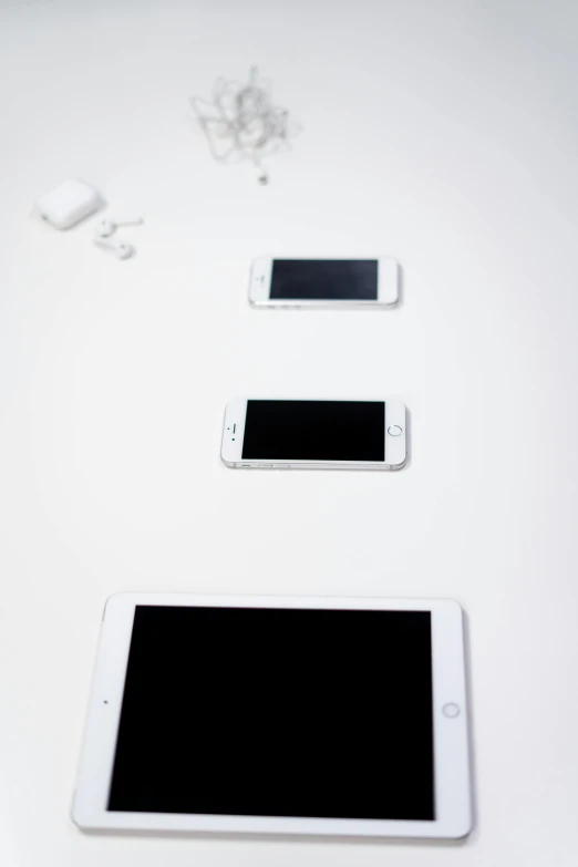 a white tablet computer sitting on top of a white table, by Simon Gaon, minimalism, cell phones, ap press photo, 256x256, various sizes