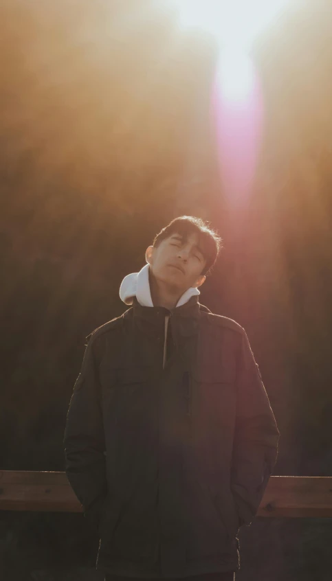 a man standing in front of the sun, an album cover, unsplash, realism, yukito kishiro, backlit shot girl in parka, profile picture, looking happy