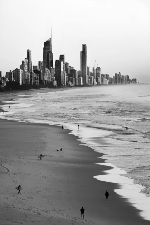 a black and white photo of surfers on the beach, by Peter Churcher, renaissance, city skyline, :: morning, desert with city in the skyline, q