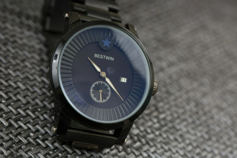 a close up of a wrist watch on a table, by Martin Benka, dark blue and black, ristan eaton, beauttiful stars, medium wide front shot