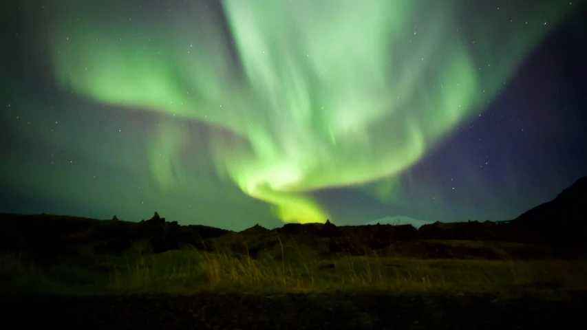 the aurora bore lights up the night sky, pexels contest winner, hurufiyya, iceland hills in the background, deep green, autumn season, turbulence