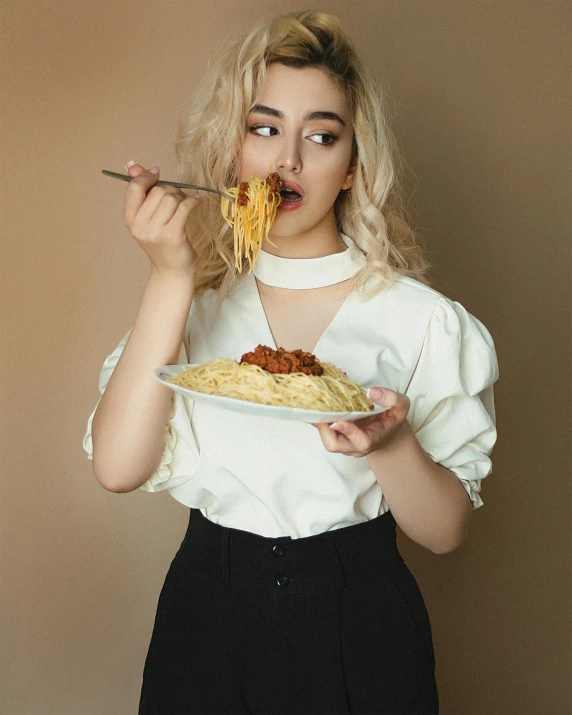 a woman holding a plate of spaghetti in front of her face, an album cover, inspired by Elsa Bleda, pexels contest winner, portrait of kim petras, charli xcx, unsplash contest winning photo, lesbians